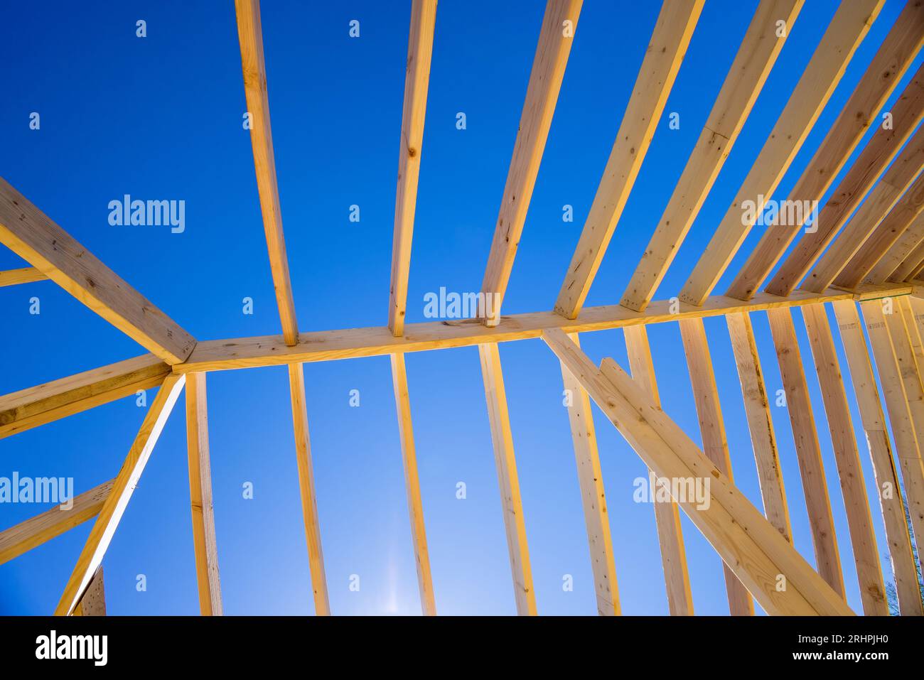 Using wood frame trusses to construct roof on new house construction