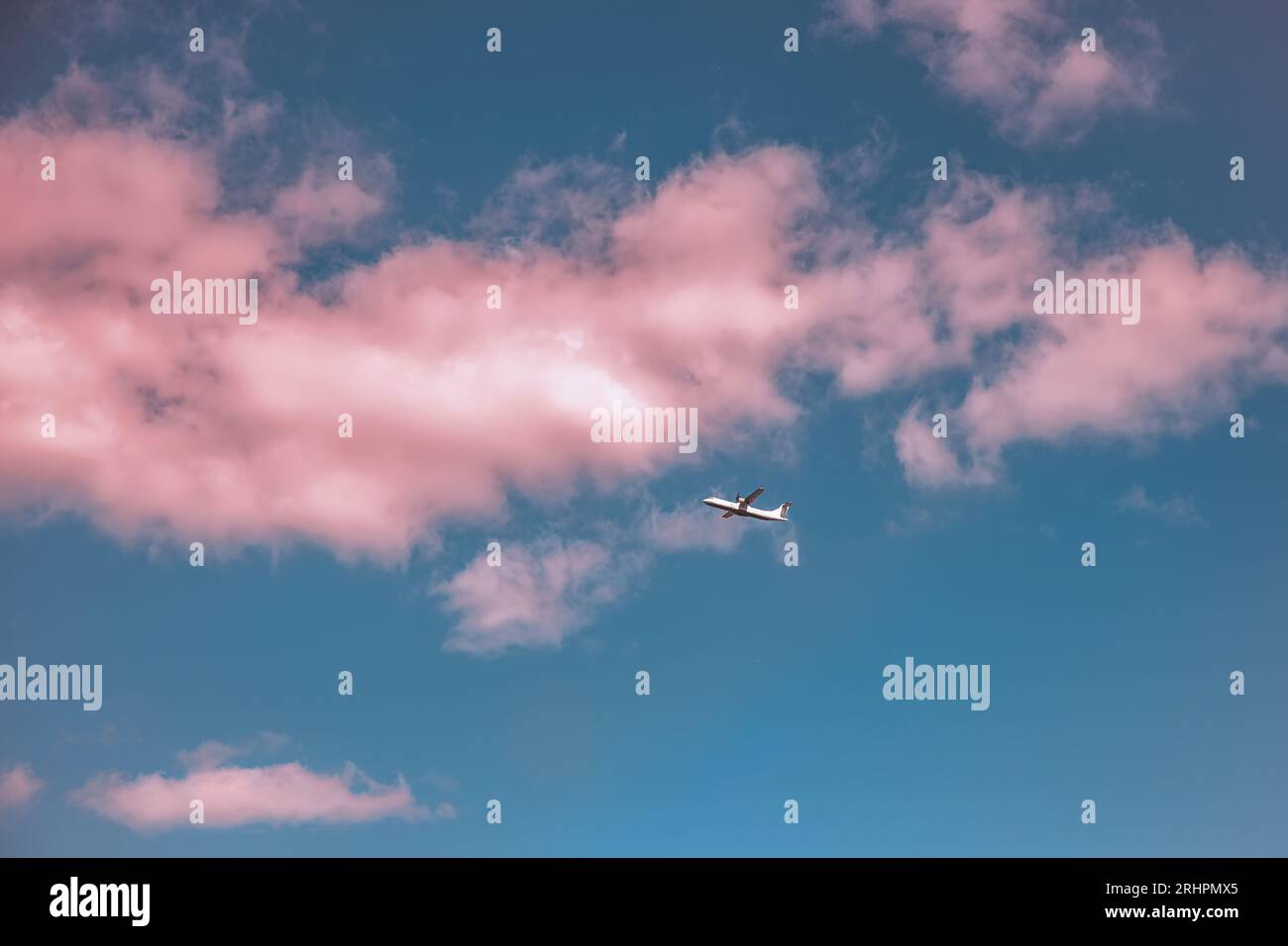 Airplane in the sky with pink clouds at sunset. Travel, freedom Stock ...