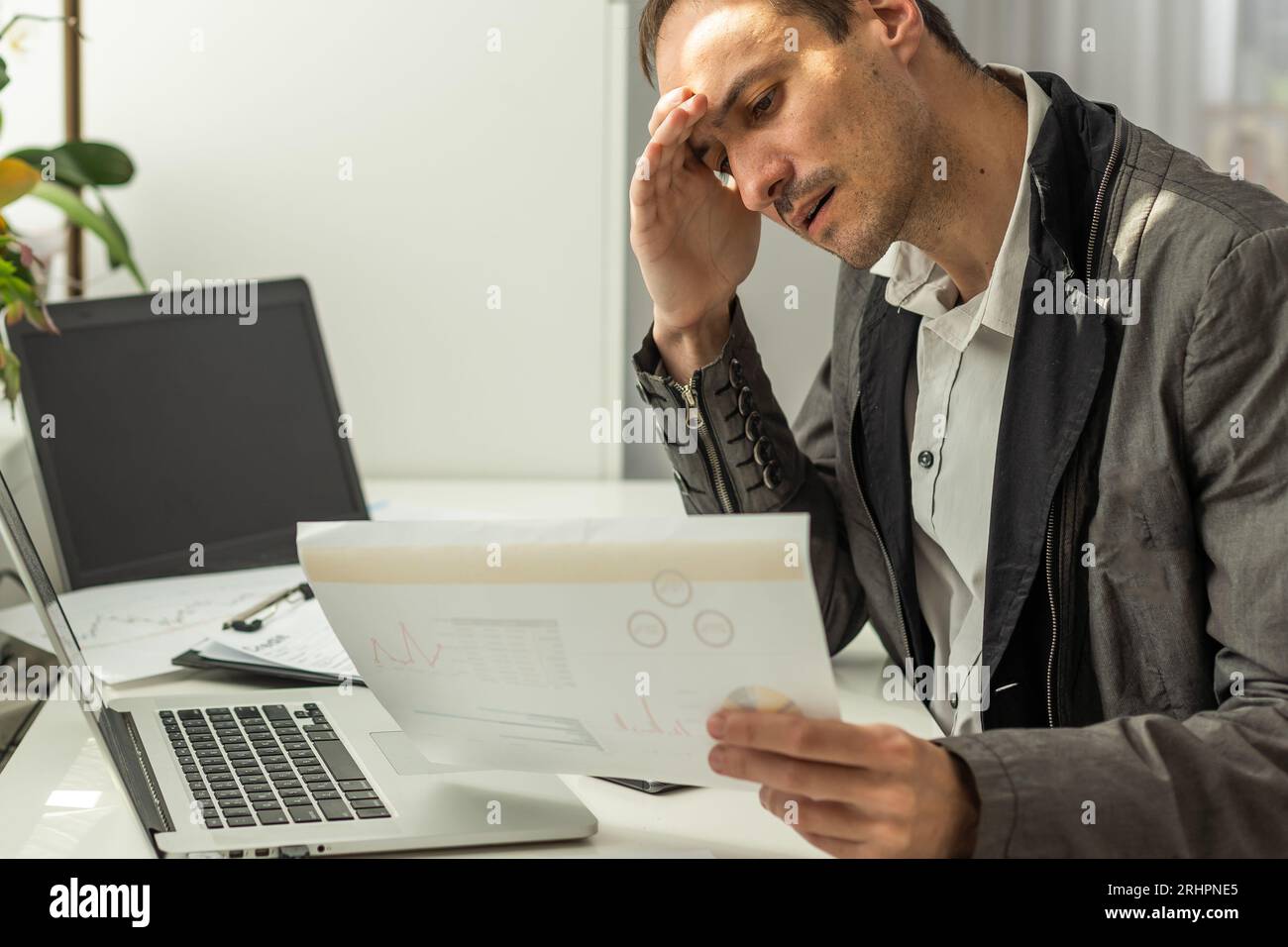 Trading stocks online. Back view of young businessman or trader working ...