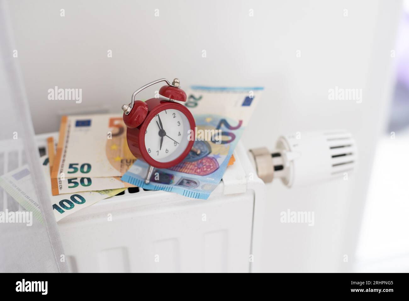 A heating radiator battery with a temperature controller from which 50