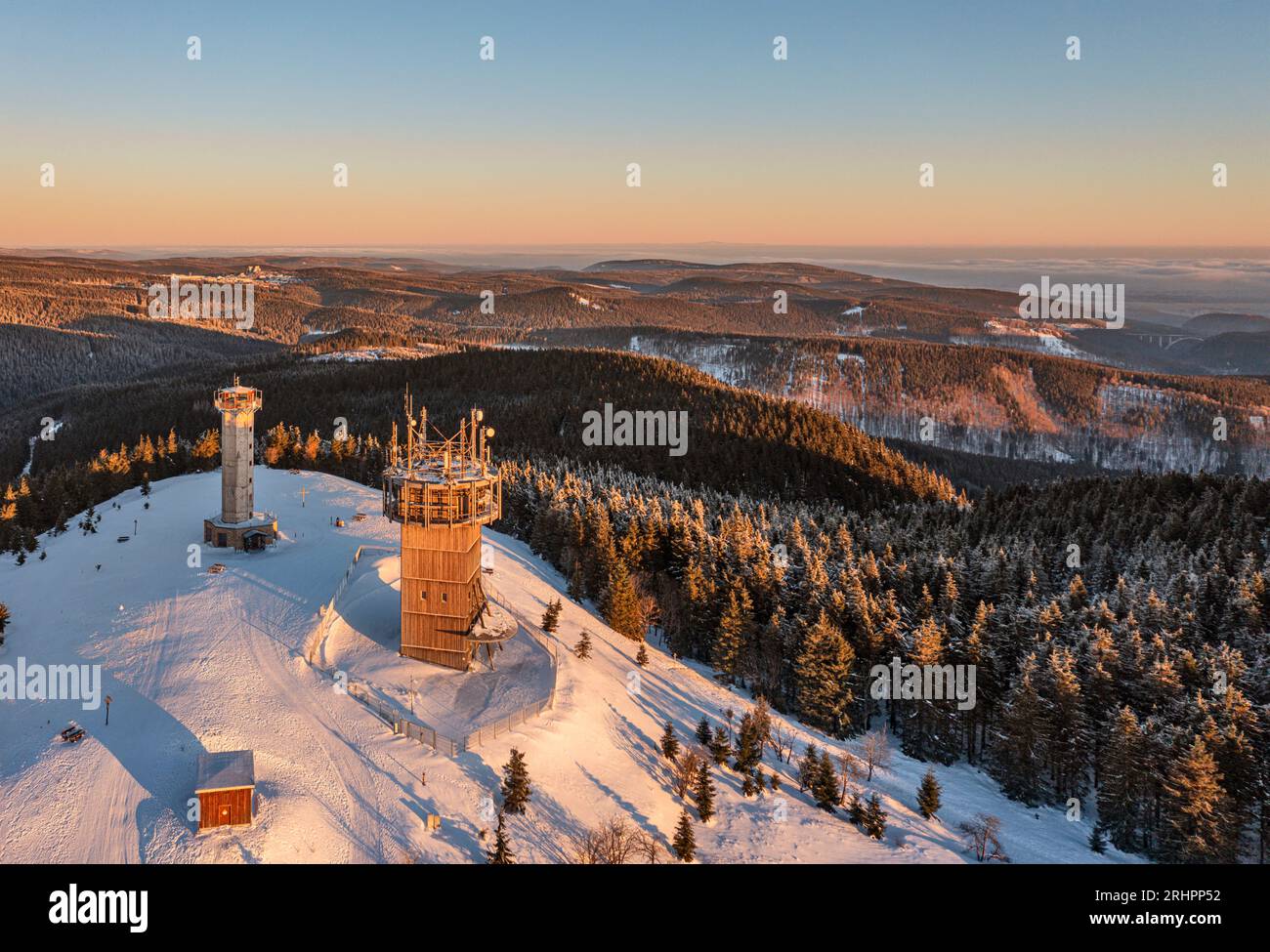 Germany, Thuringia, Suhl, Gehlberg, Schneekopf (second highest mountain of Thuringian Forest), telecommunications tower, observation and climbing tower, Oberhof (background), forest, mountains, snow, overview, morning light, aerial photo Stock Photo