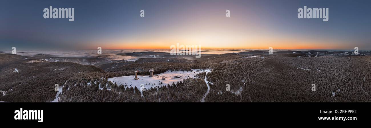 Germany, Thuringia, Suhl, Gehlberg, Schneekopf (second highest mountain of Thuringian Forest), lookout and climbing tower, telecommunication tower, New Gehlberg Hut, forest, mountains, snow, dawn, backlight, overview, aerial photo, panorama photo Stock Photo