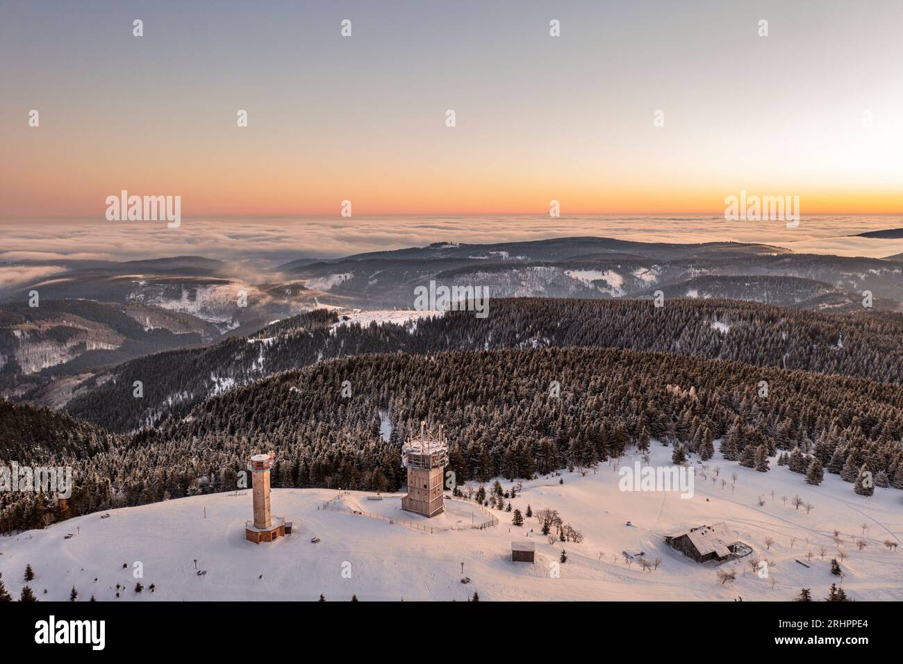 Germany, Thuringia, Suhl, Gehlberg, Schneekopf (second highest mountain of Thuringian Forest), observation and climbing tower, telecommunication tower, New Gehlberg Hut, forest, mountains, snow, overview, dawn, aerial photo Stock Photo