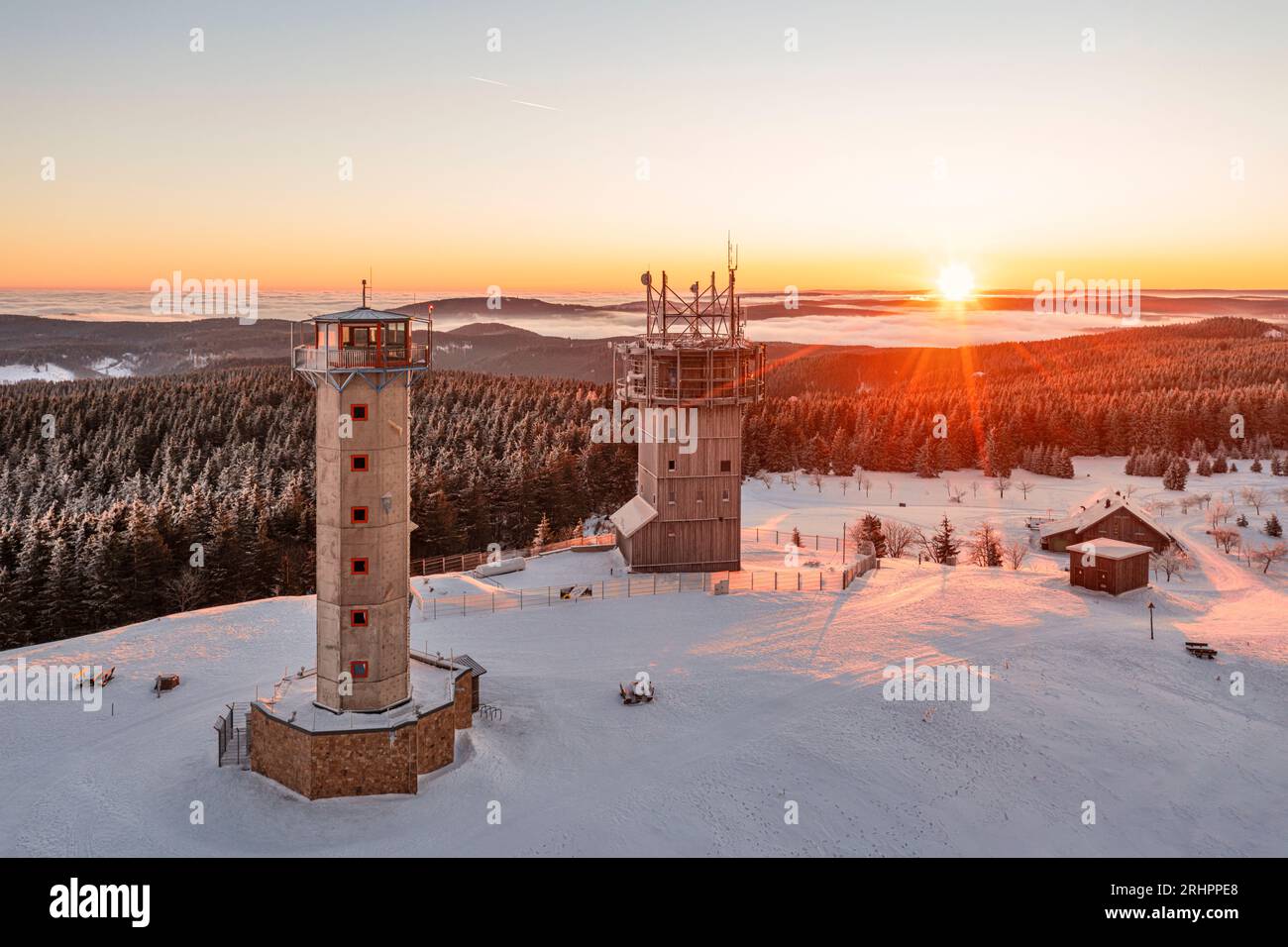 Germany, Thuringia, Suhl, Gehlberg, Schneekopf (second highest mountain of Thuringian Forest), observation and climbing tower, telecommunication tower, New Gehlberg Hut, forest, mountains, snow, sunrise, backlight, overview, aerial photo Stock Photo