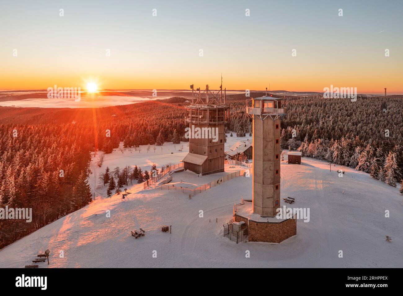 Germany, Thuringia, Suhl, Gehlberg, Schneekopf (second highest mountain of Thuringian Forest), observation and climbing tower, telecommunication tower, forest, mountains, snow, sunrise, overview, back light Stock Photo