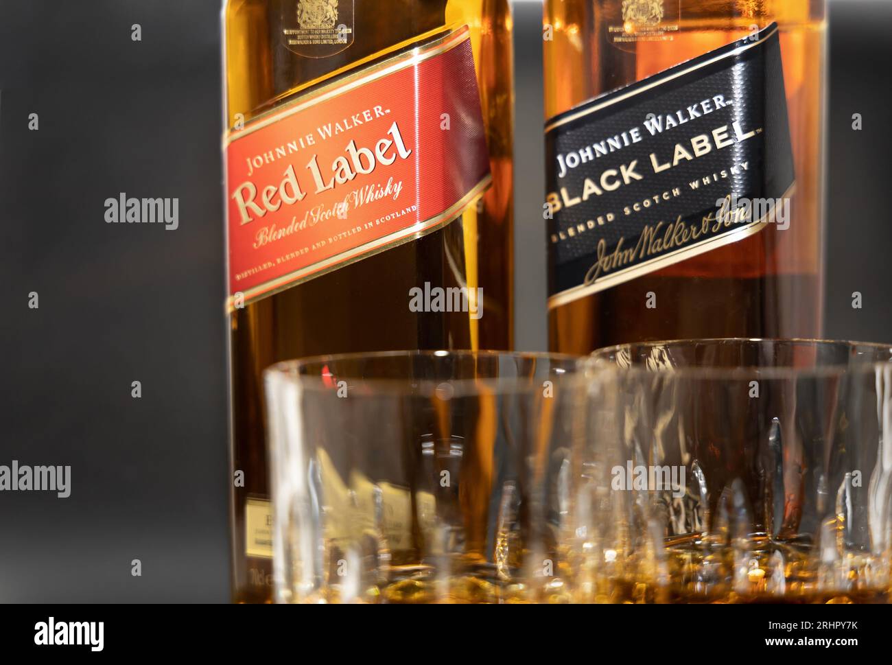 Two glasses of whiskey on the background of a bottle of wiskey Johnnie Walker, Red Label and