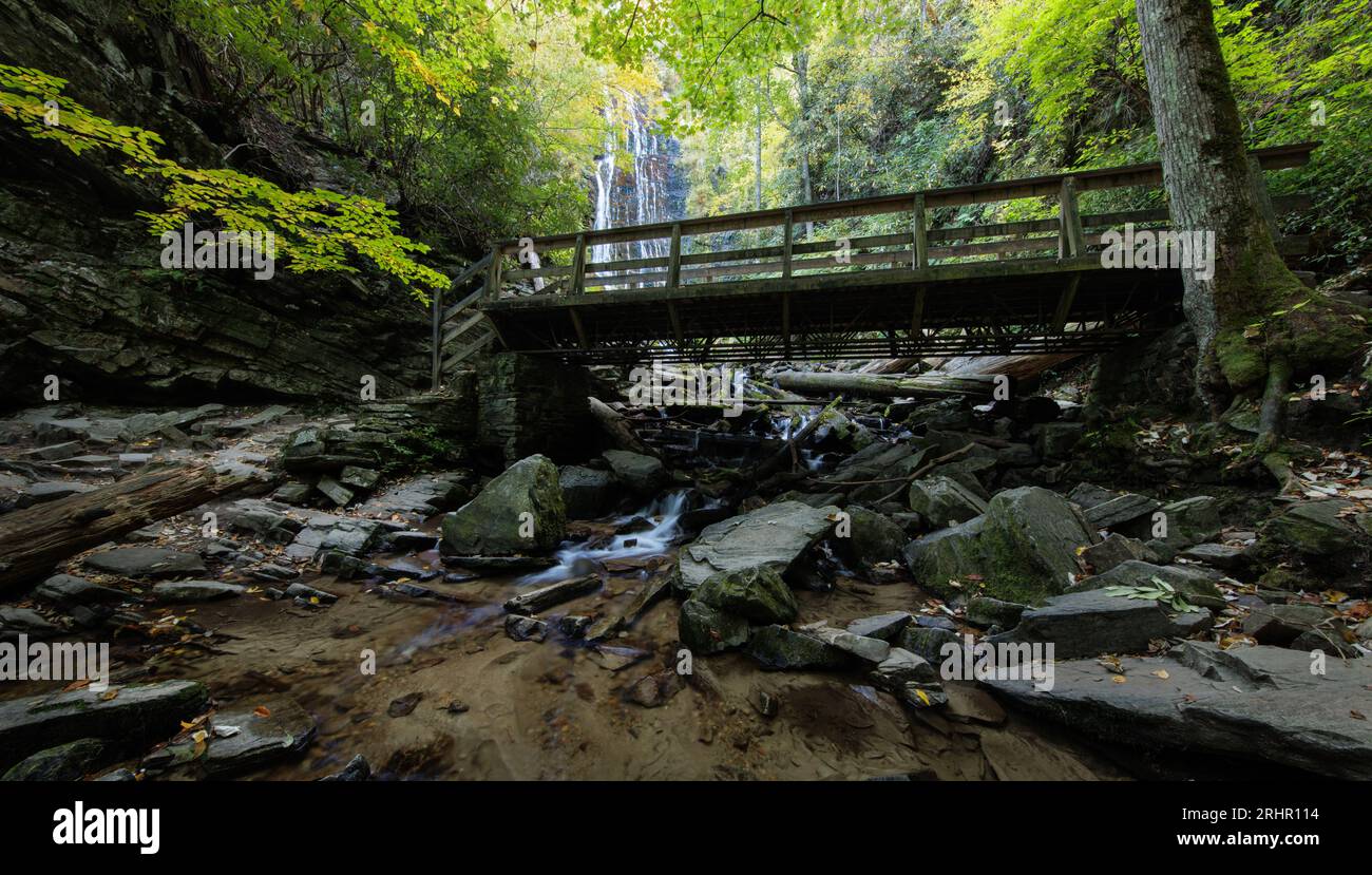 Mingo Falls, Qualla Boundary - Swain County, North Carolina.. A wood bridge crosses Mingo Creek just downstream of Mingo Falls. Stock Photo
