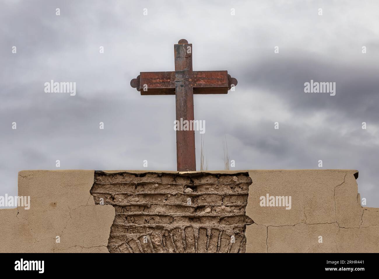 A cross on a deteriorating cemetery gate near El Paso, Texas. Stock Photo