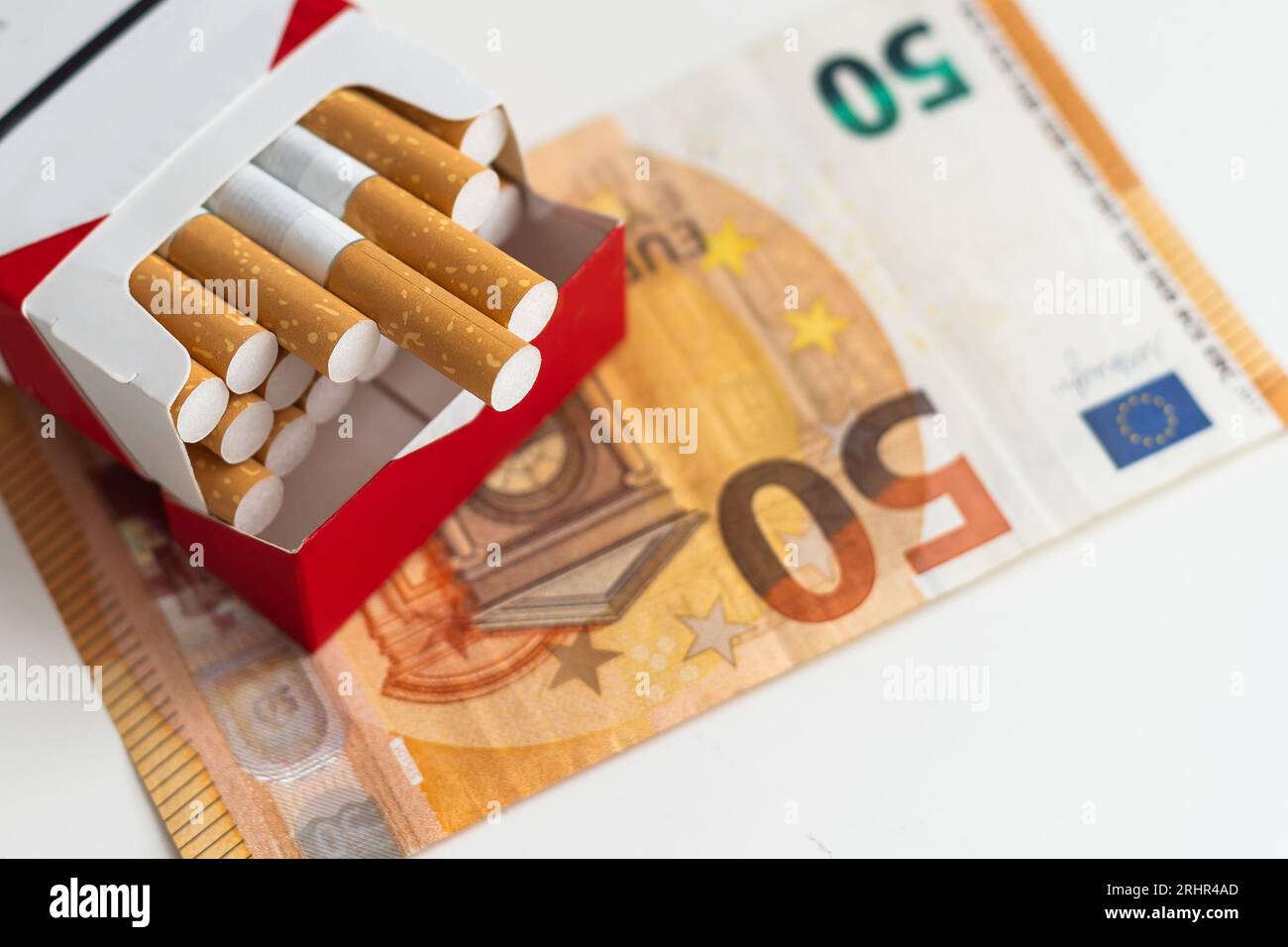 Pack of cigarettes on the euro bills. Close up. Stock Photo