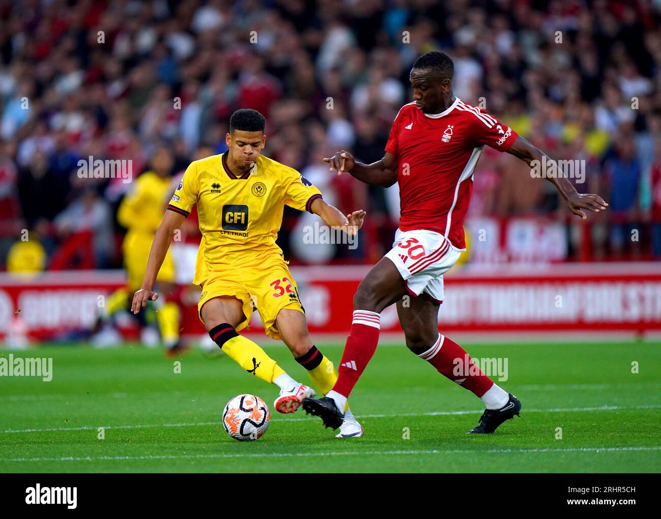 Sheffield United's William Osula (left) and Nottingham Forest's Willy Boly battle for the ball during the Premier League match at the City Ground, Nottingham. Picture date: Friday August 18, 2023. Stock Photo