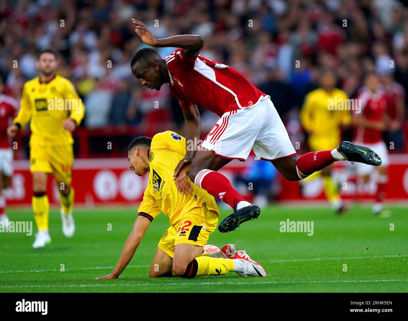 Nottingham Forest's Willy Boly clashes into Sheffield United's William Osula as they battle for the ball during the Premier League match at the City Ground, Nottingham. Picture date: Friday August 18, 2023. Stock Photo