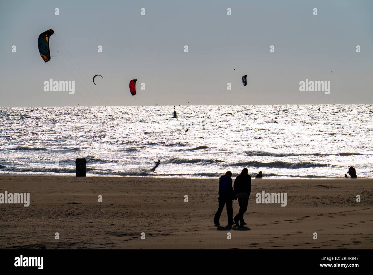 Kitesurfers off the coast of Scheveningen, walkers on the beach, The Hague, Netherlands Stock Photo