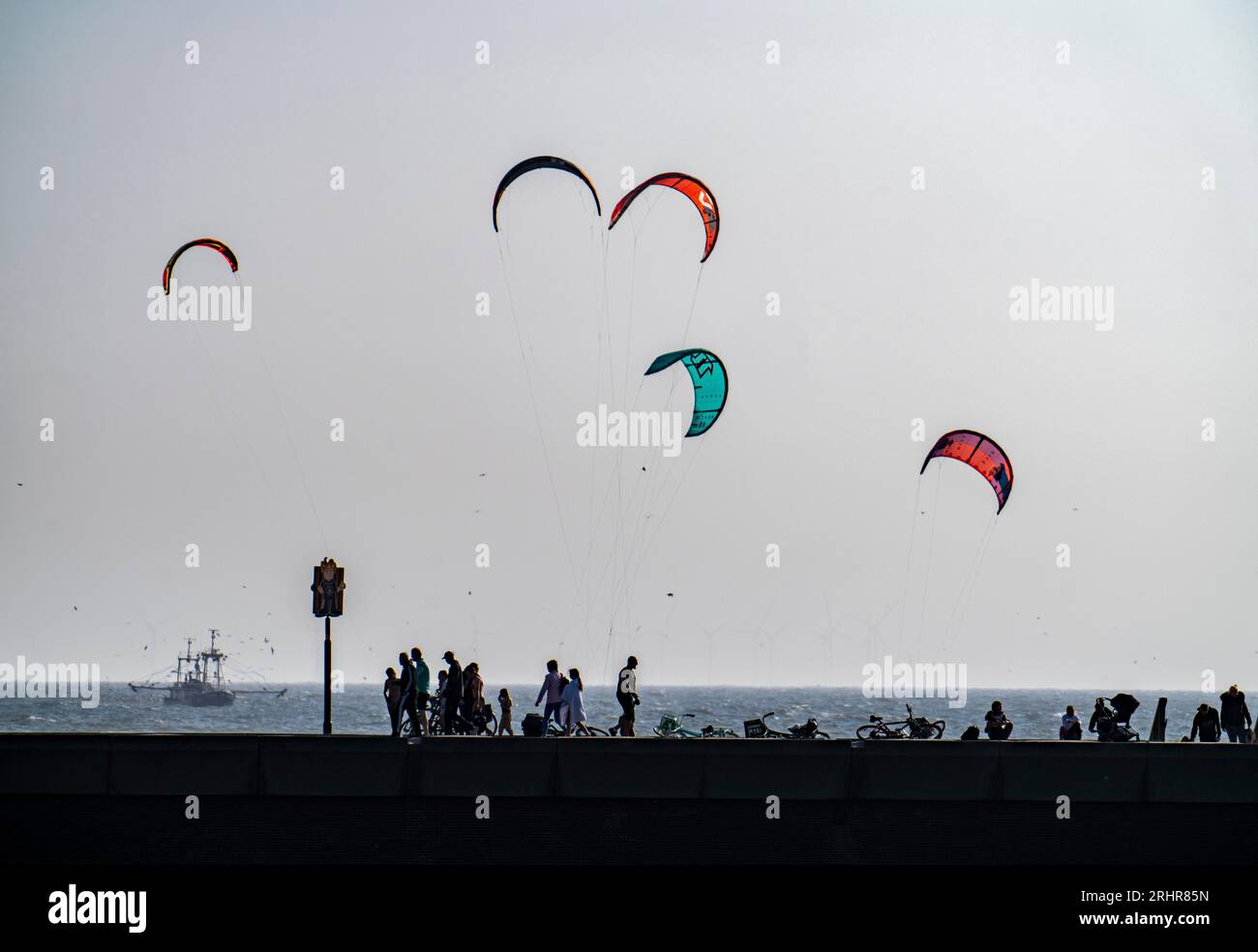 Kitesurfers off the coast of Scheveningen, strollers on the pier, The Hague, Netherlands Stock Photo