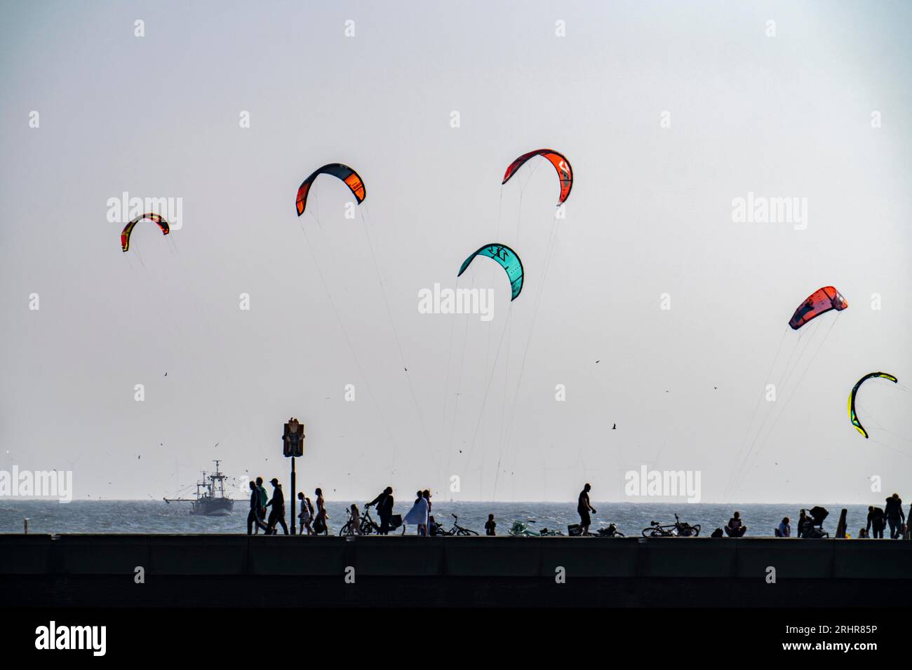 Kitesurfers off the coast of Scheveningen, strollers on the pier, The Hague, Netherlands Stock Photo