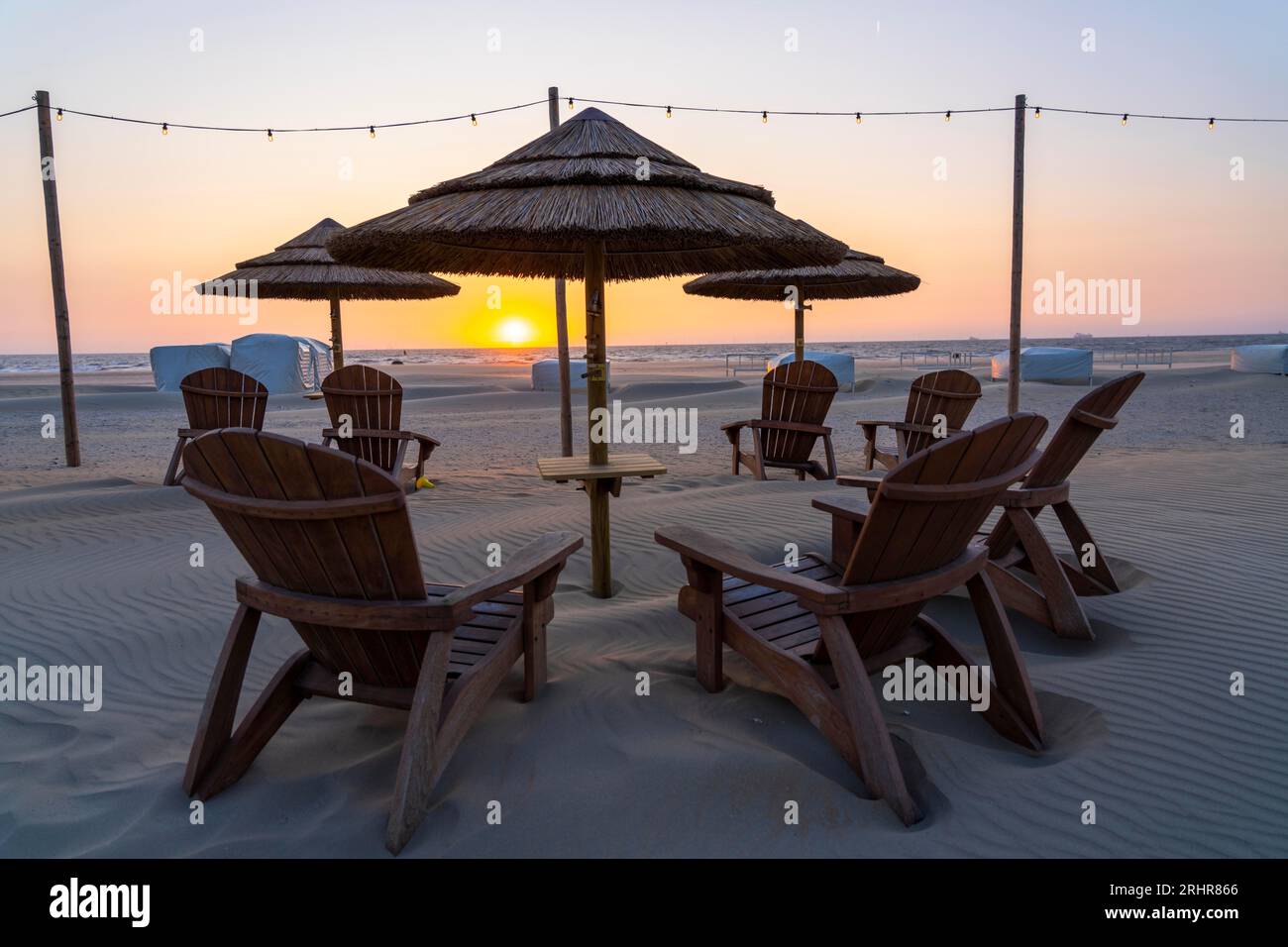 Beach restaurant, furniture on the beach of Scheveningen, sunset, Netherlands Stock Photo
