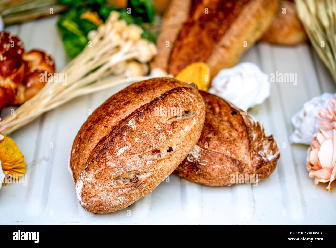 A rustic loaf of sourdough bread on white background Stock Photo