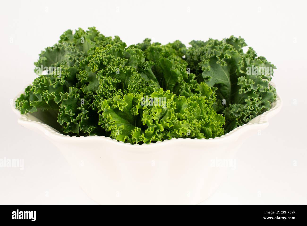 bright leafy green kale in decorative bowl Stock Photo