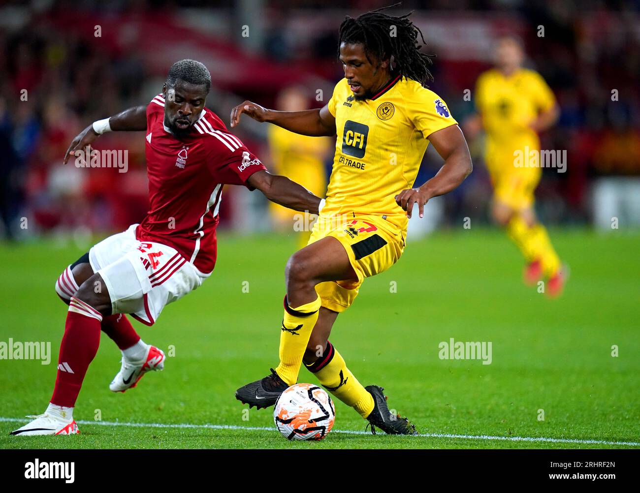 Nottingham Forest's Serge Aurier (left) and Sheffield United's Yasser Larouci battle for the ball during the Premier League match at the City Ground, Nottingham. Picture date: Friday August 18, 2023. Stock Photo