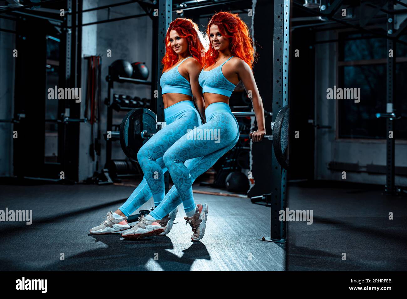 Young sports twins girls team posing in gym Stock Photo