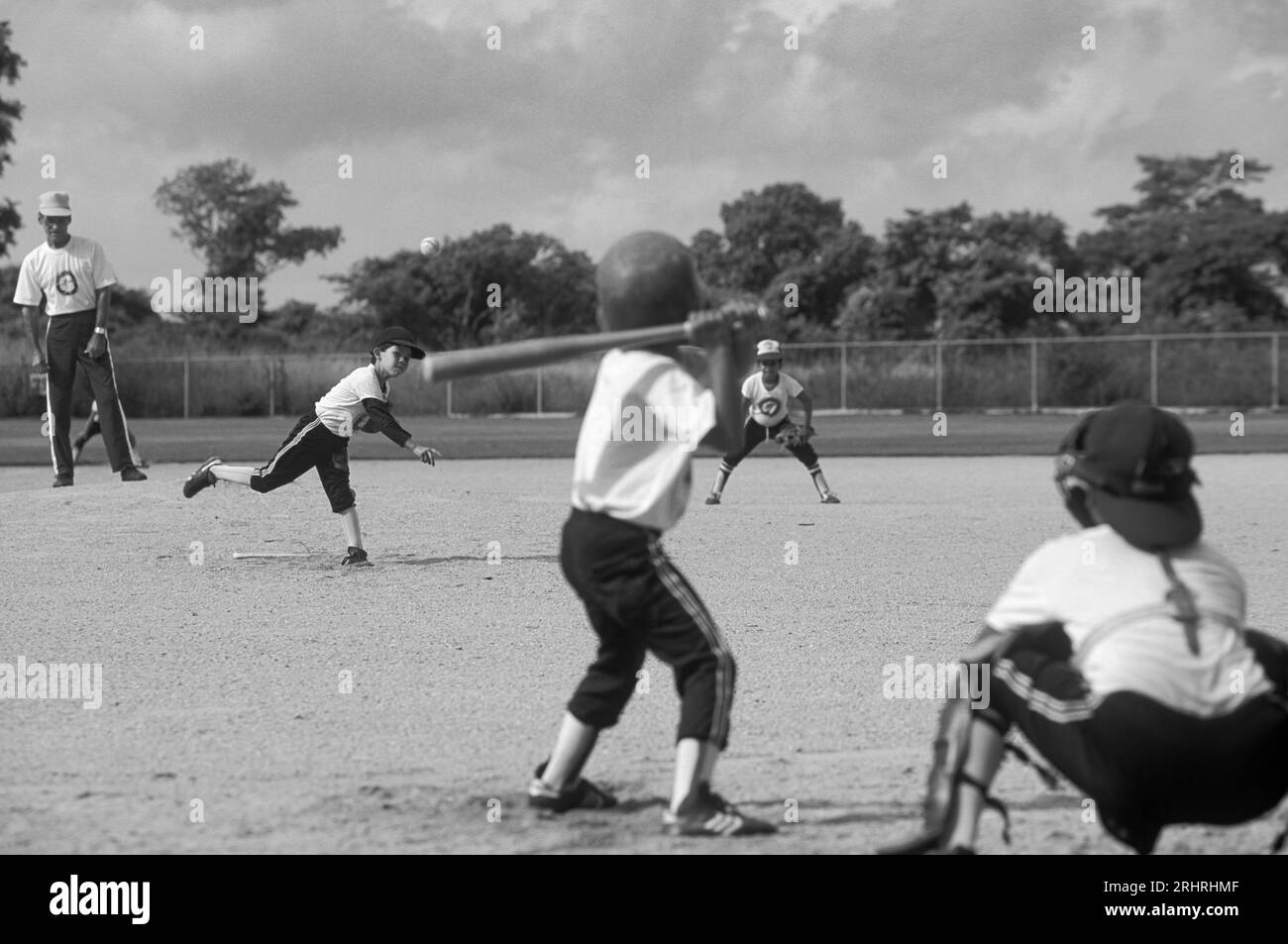 Boys playing baseball in a baseball field Stock Photo Alamy