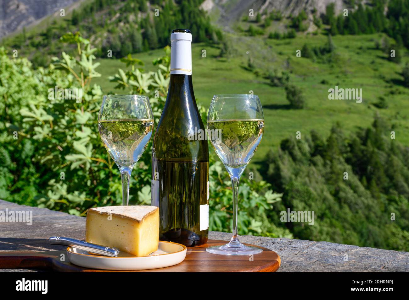 Cheese and wine, glasses of dry white Roussette de Savoie and Vin de Savoie wine from Savoy