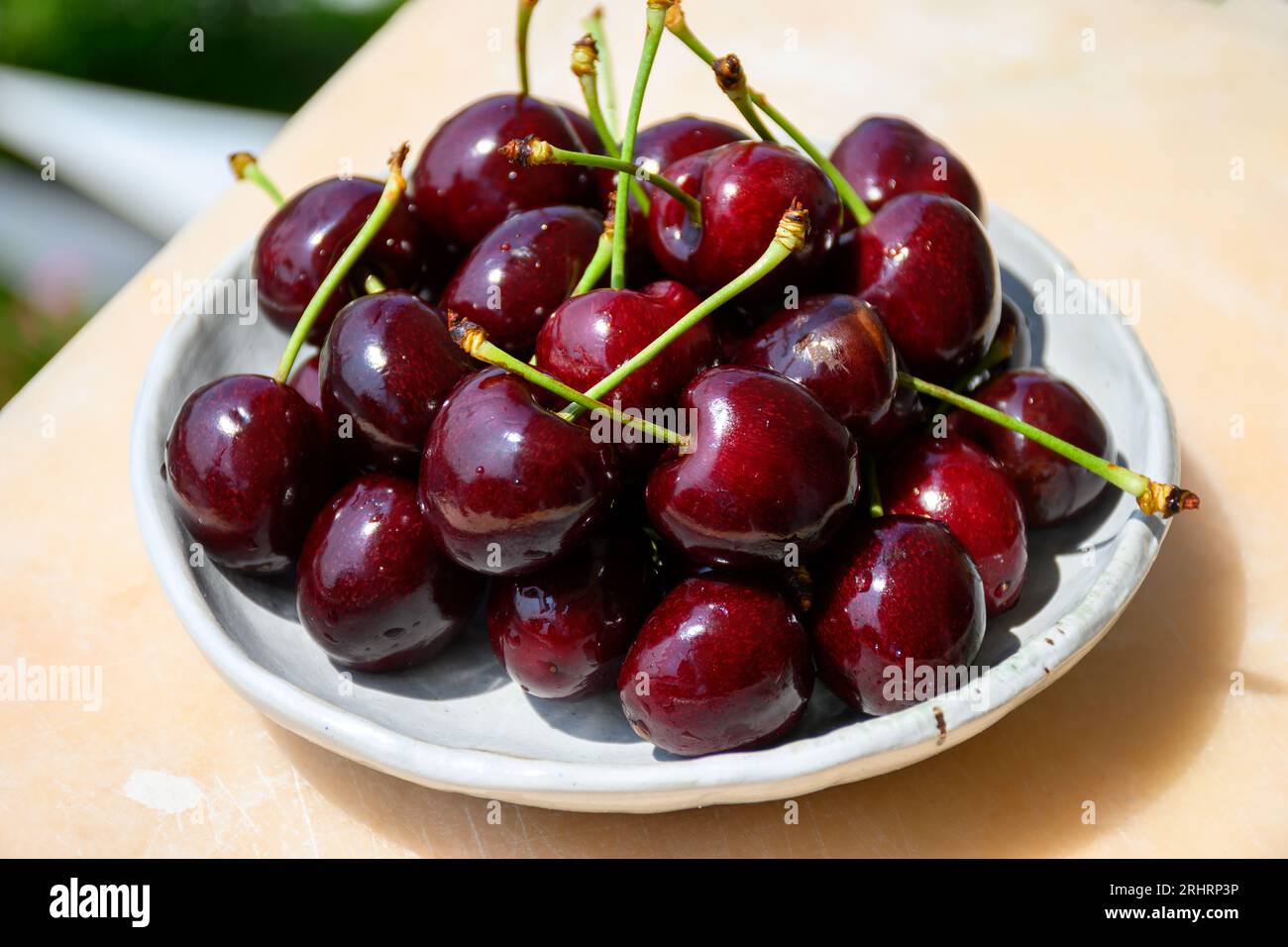 New harvest of fresh ripe dark red cherry berry served outdoor in Provence, France close up Stock Photo