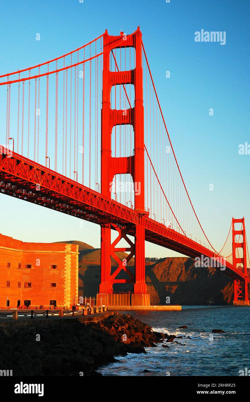 The historic Fort Ross, built to protect the San Francisco Bay Area, is dwarfed by the iconic Golden Gate Bridge Stock Photo