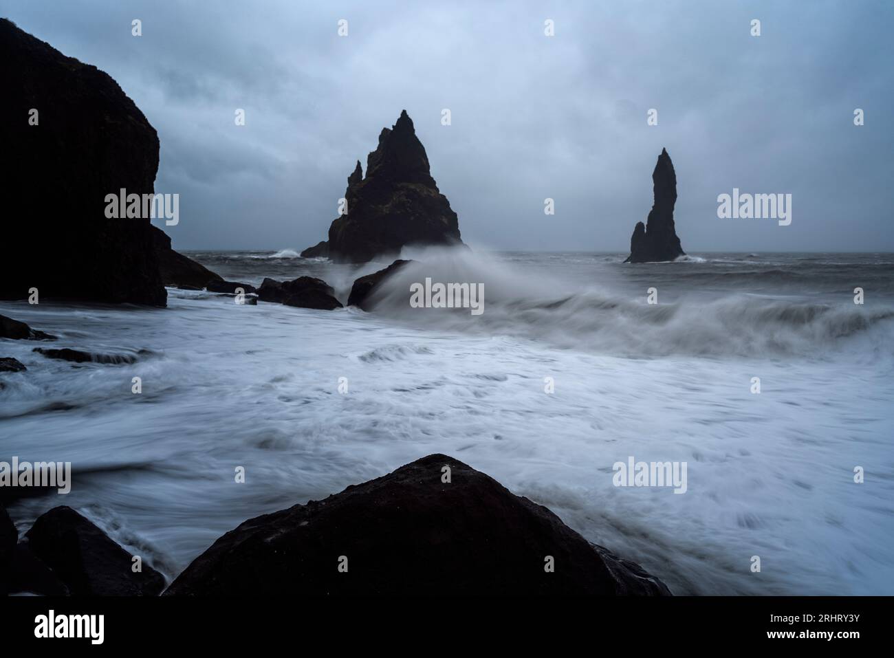 Black Sand Beach in Iceland. White waves crash onto the inky Icelandic