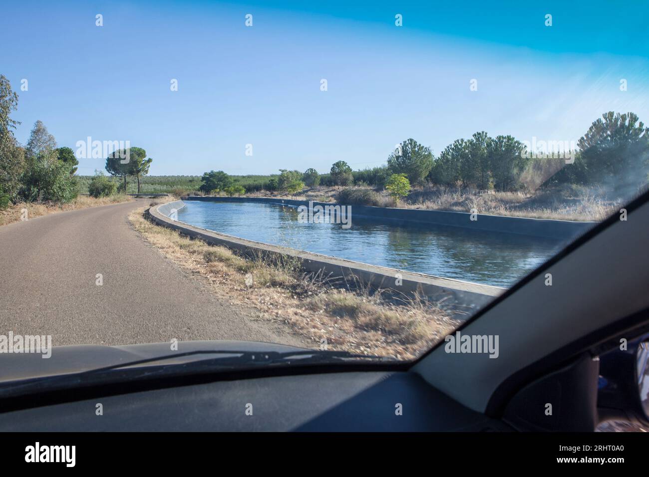 Driving beside irrigation canal. Vegas Altas del Guadiana, Badajoz, Extremadura, Spain Stock Photo