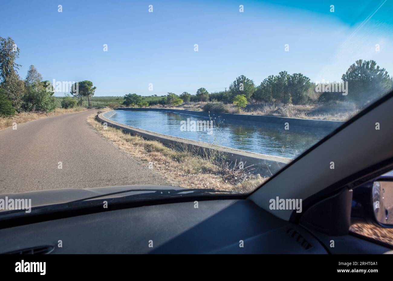 Driving beside irrigation canal. Vegas Altas del Guadiana, Badajoz, Extremadura, Spain Stock Photo