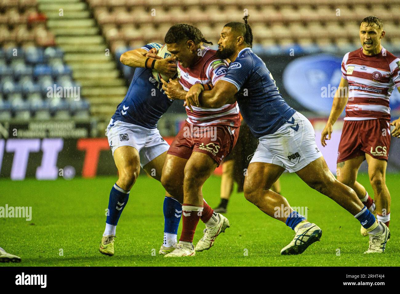 Warriors Patrick Mago is tackled by Hull FCs Chris Satae during the BetFred Super League match between Wigan Warriors and Hull Football Club at the DW Stadium, Wigan on Friday 18th August