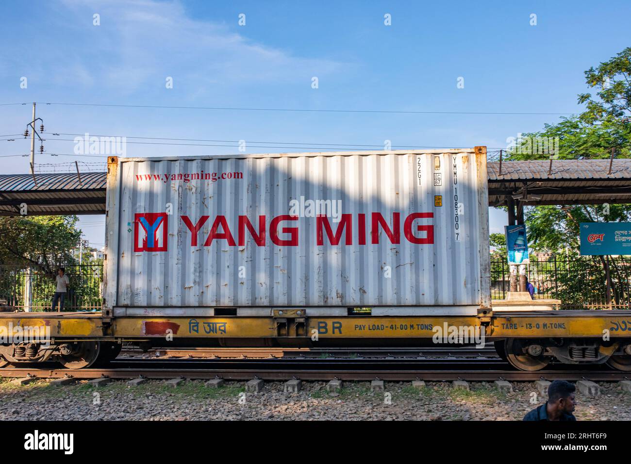 A shipping container trail cross the Airport Railway Station in Dhaka ...