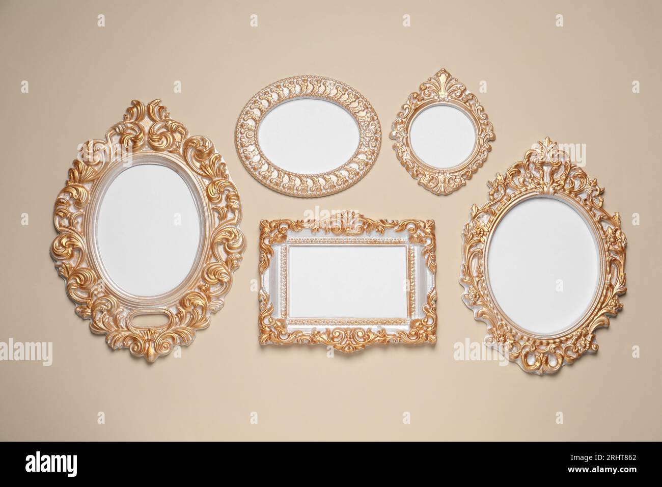 Empty vintage frames hanging on beige wall Stock Photo - Alamy