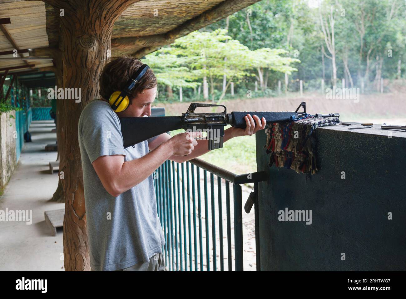 Boy firing rifle at shooting range at Cu Chi Tunnels near Ho Chi Minh