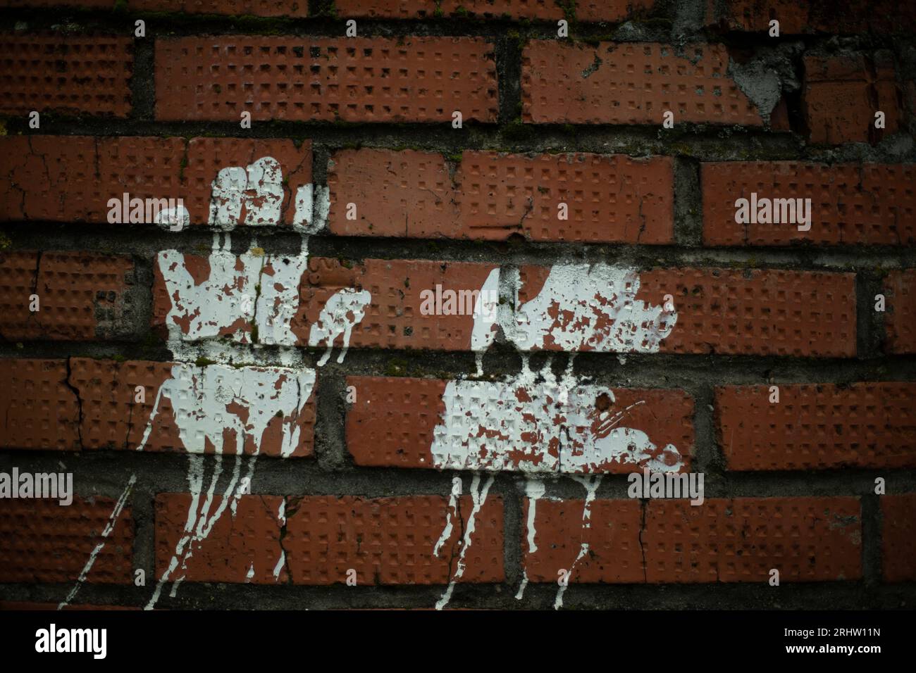 Handprint paint. Imprint on brick wall. White paint silhouette of palm