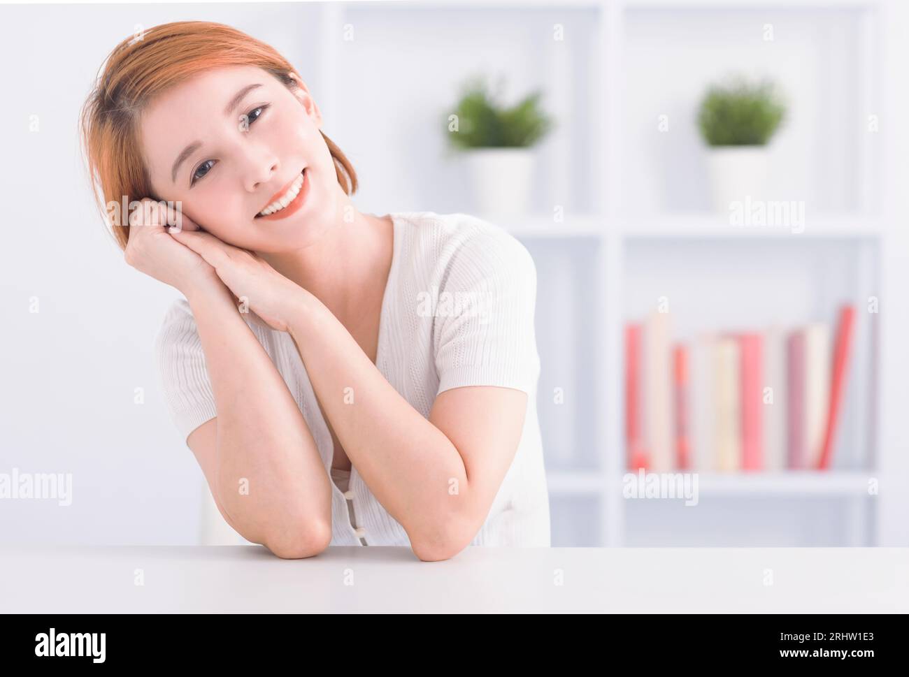 Happy asian young woman in living room Stock Photo