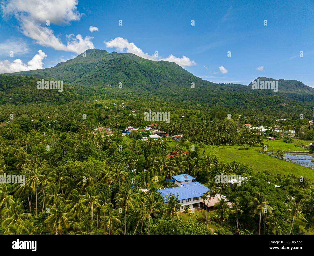 Evergreen mountain and agricultural land with rice fields in Camiguin ...