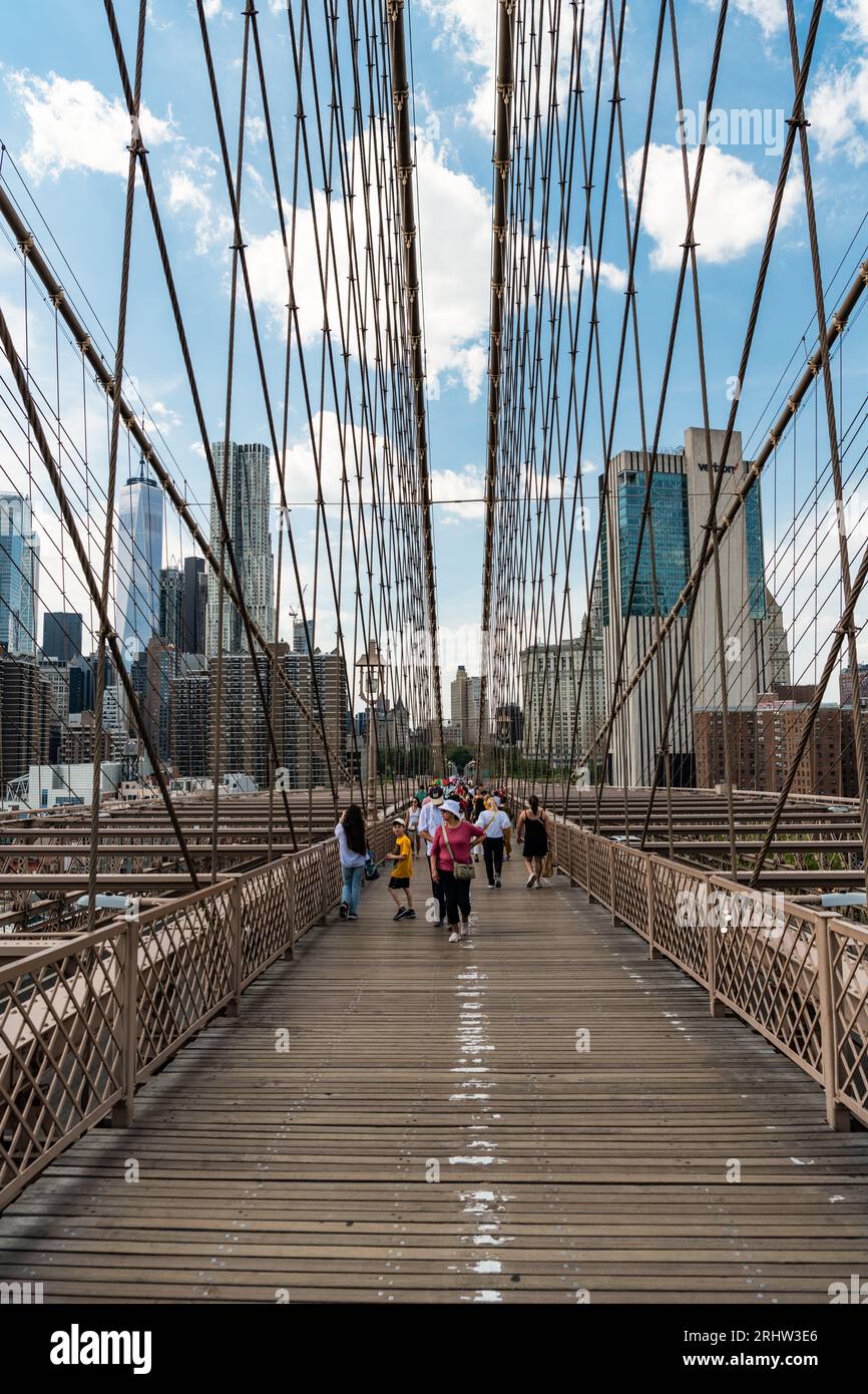 New York City, USA - May 12, 2023: brooklyn bridge way to manhattan with people, midtown. Stock Photo