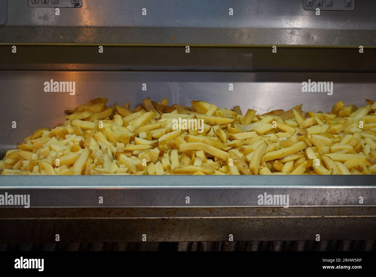 French fries in deep fryer at restaurant kitchen Stock Photo Alamy