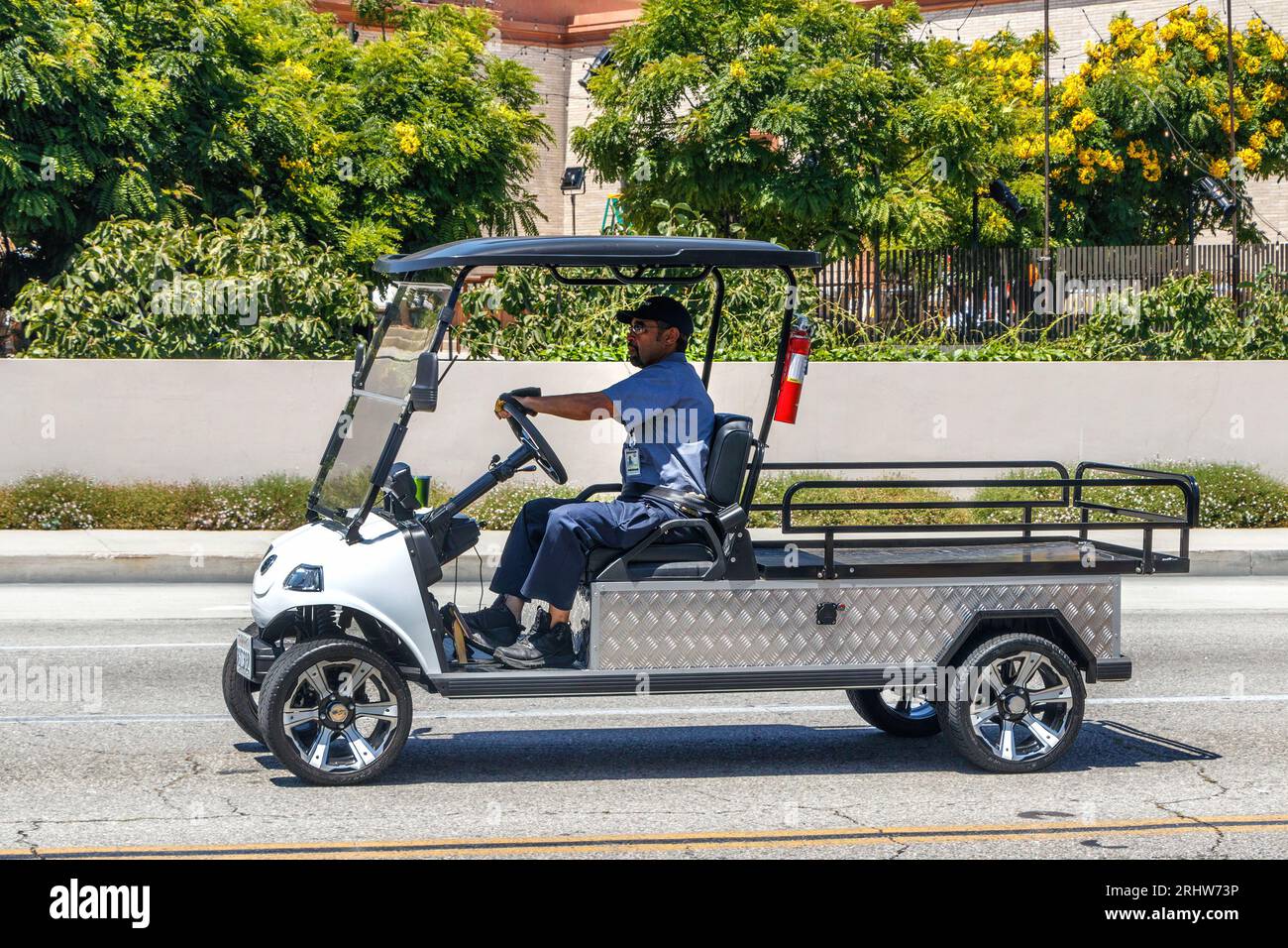 small electric vehicle delivery utility truck driving in Beverly Hills ...