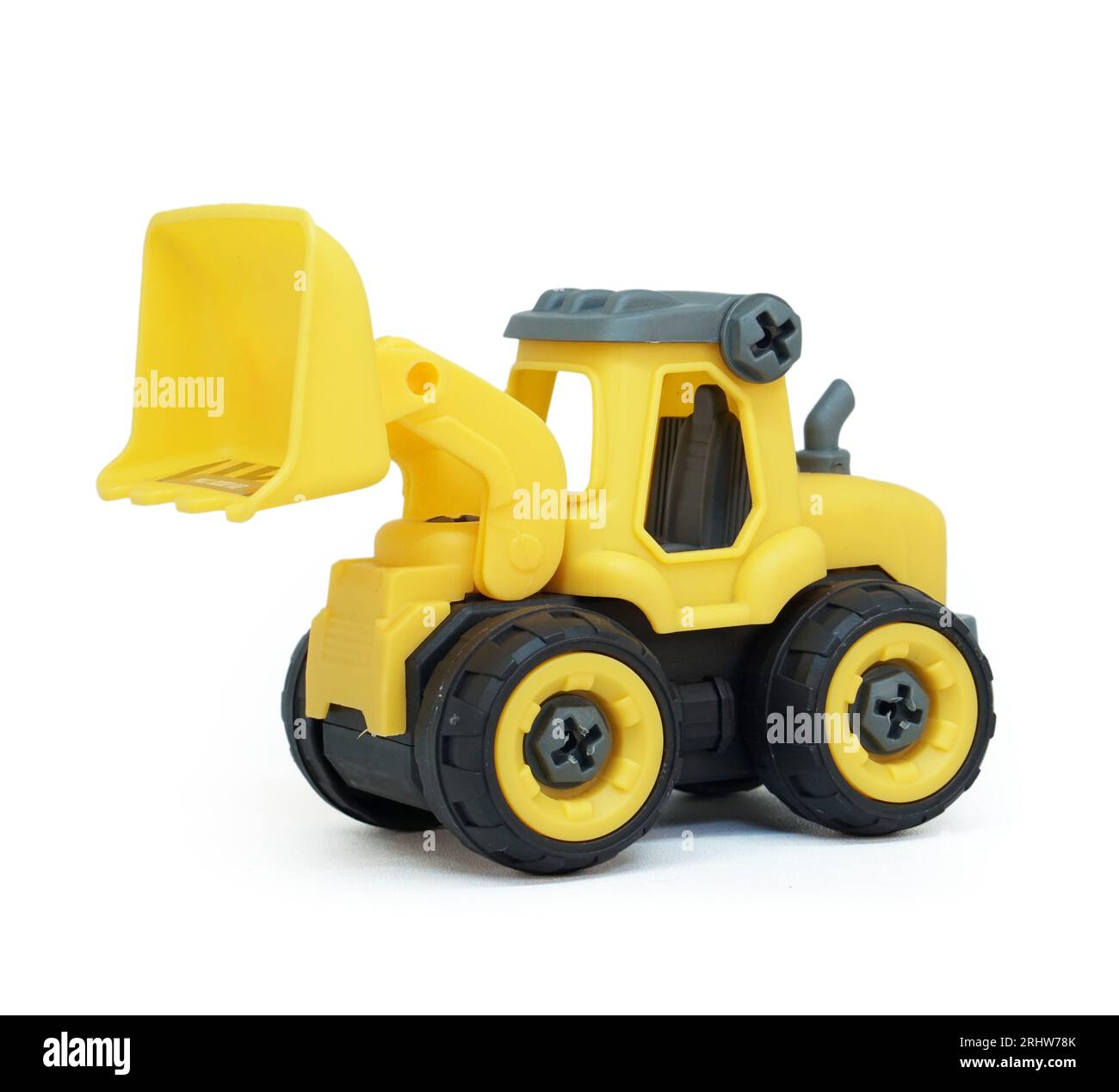 yellow plastic bulldozer toy isolated on white background. heavy construction vehicle toy. Stock Photo