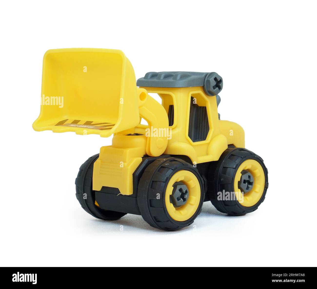 yellow plastic bulldozer toy isolated on white background. heavy construction vehicle toy. Stock Photo