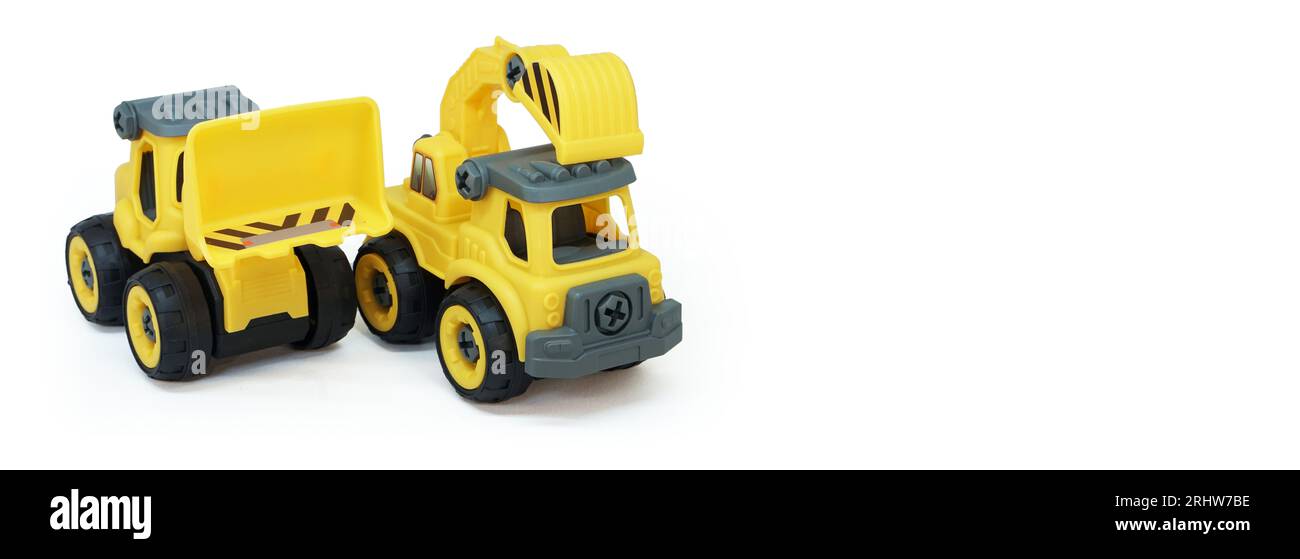 yellow plastic truck and bulldozer toy isolated on white background with copy space for text or banner Stock Photo