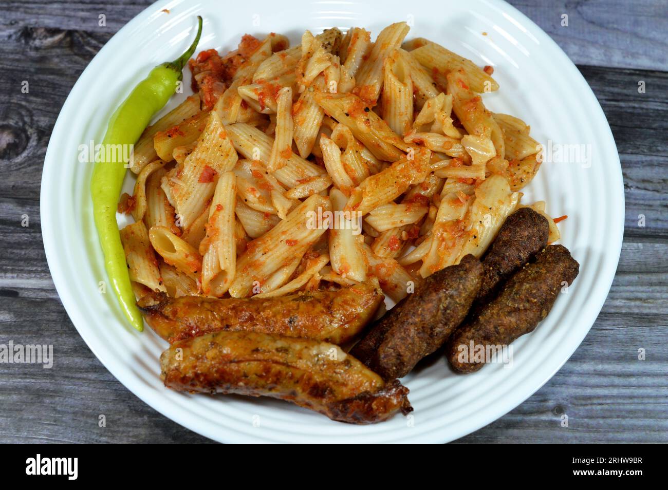 A plate of classic pasta penne macaroni with tomato sauce, Egyptian classic homemade sausage of