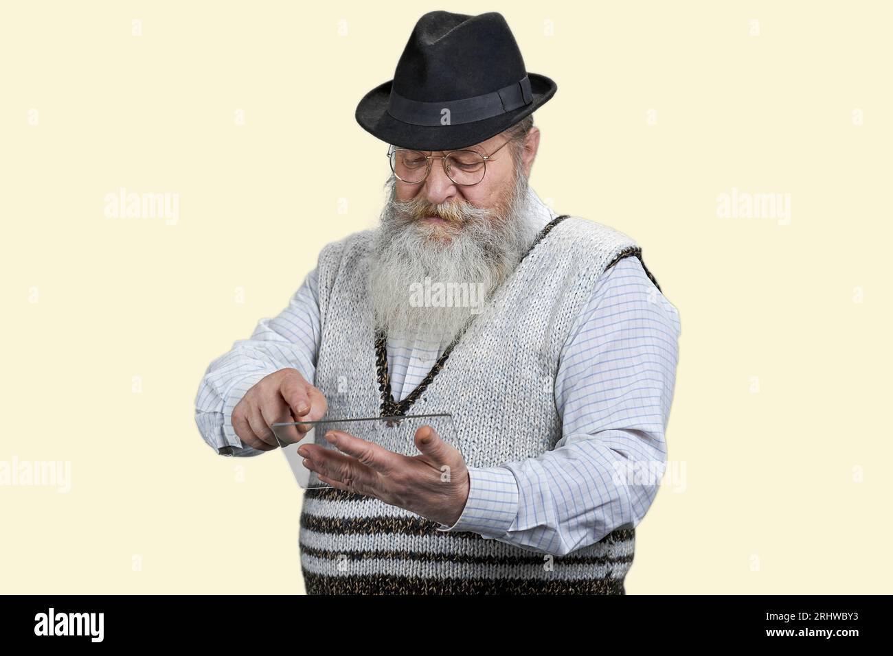 Portrait of old man scrolling mockup tablet pc. Isolated on white. Stock Photo