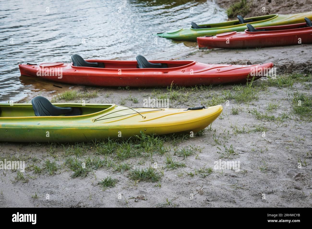Several empty colorful kayaks on the beach Stock Photo - Alamy