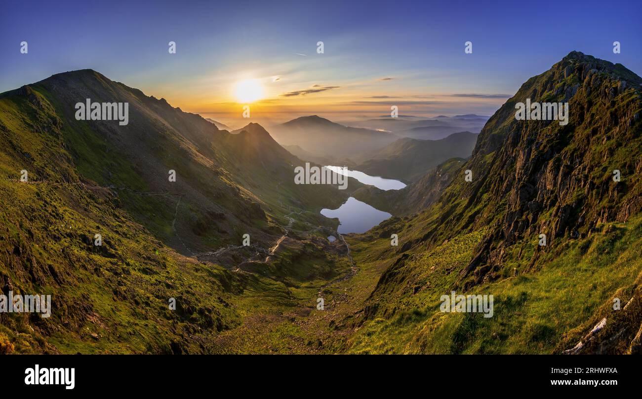 Snowdonia. The sunrise view fromthe top of Mount Snowdon, Yr Wyddfa, looking east towards Glaslyn lake ( nearest camera ) and Llyn Llydaw behind. Snow Stock Photo