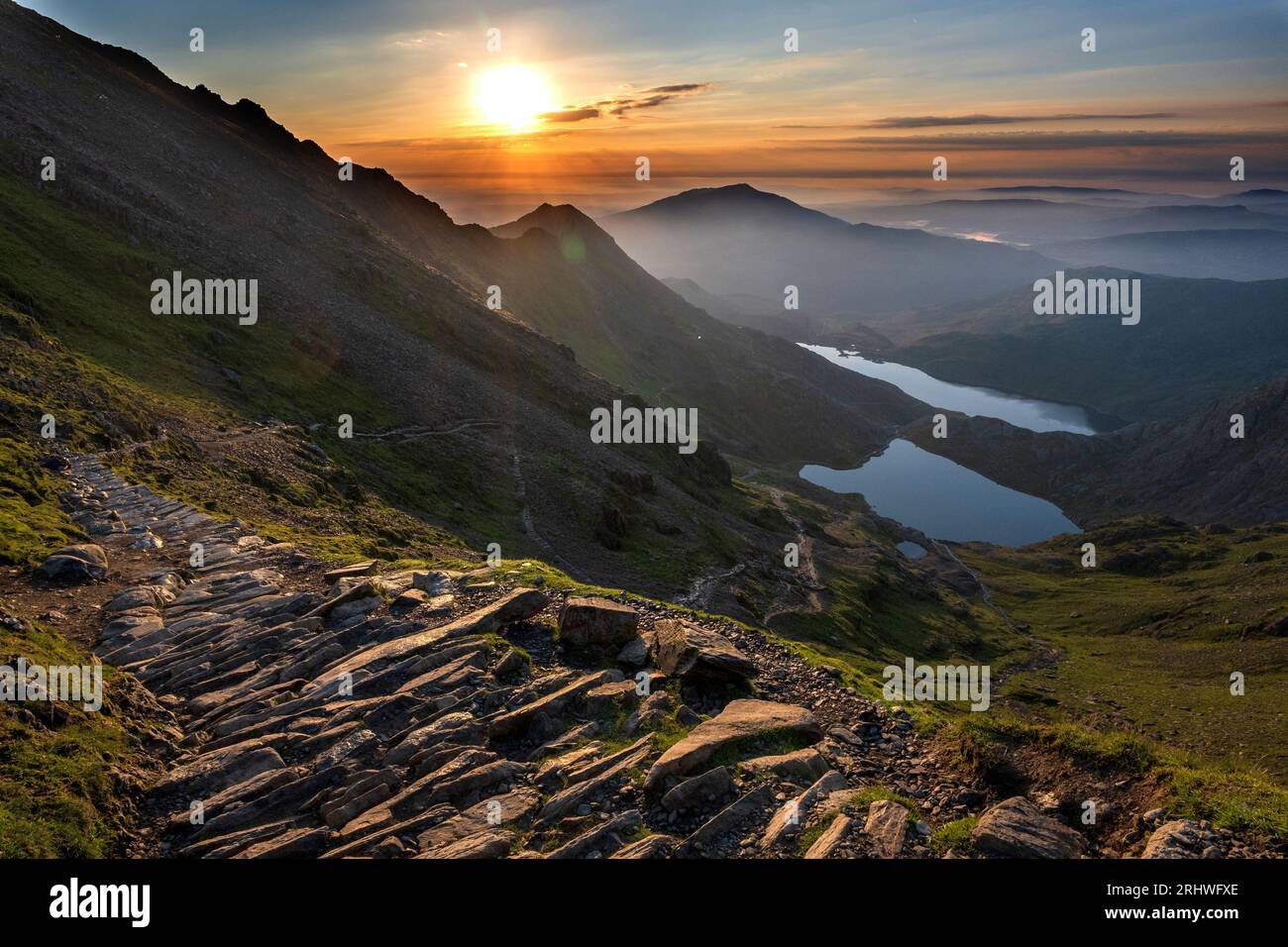 Snowdonia. The sunrise view fromthe top of Mount Snowdon, Yr Wyddfa, looking east towards Glaslyn lake ( nearest camera ) and Llyn Llydaw behind. Snow Stock Photo