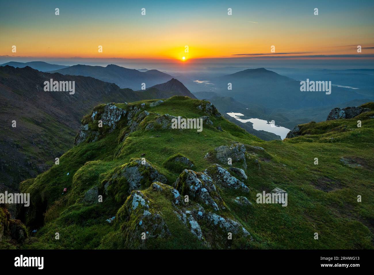 Snowdonia. The sunrise view fromthe top of Mount Snowdon, Yr Wyddfa, looking east towards Glaslyn lake ( nearest camera ) and Llyn Llydaw behind. Snow Stock Photo