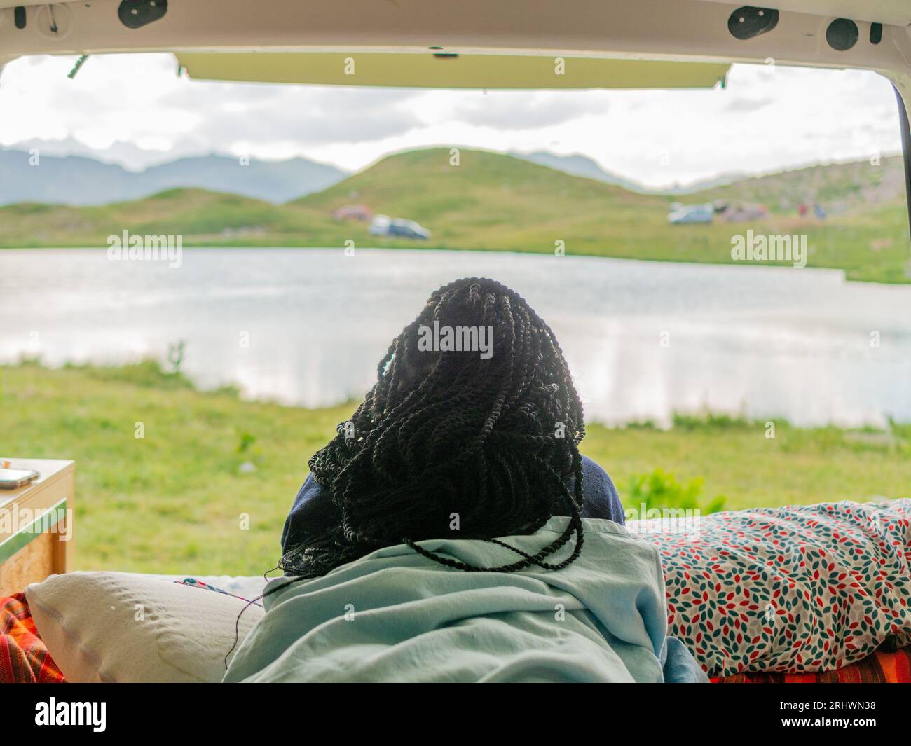 young woman enjoying nature from the interior of a campervan Stock Photo